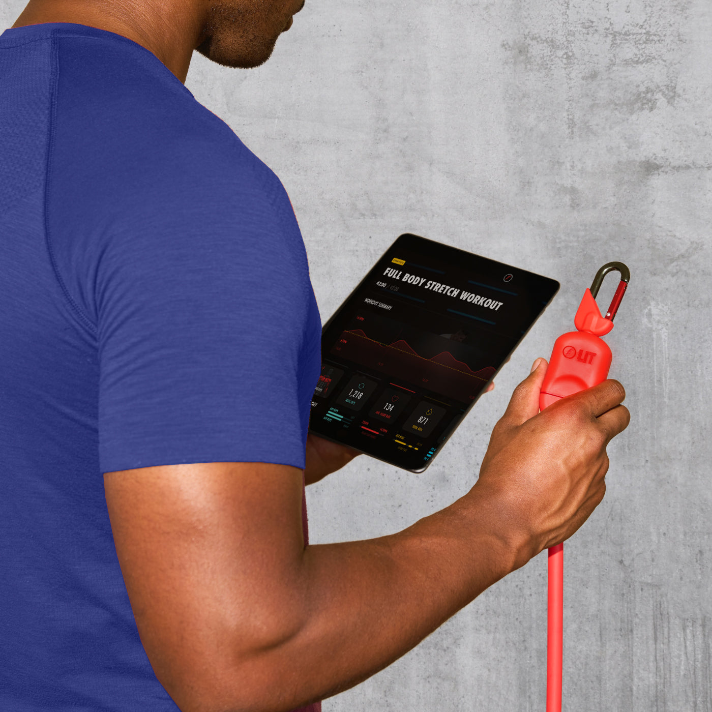 A man holding the LIT Axis resistance band and LIT App on tablet showing metrics that are getting tracked
