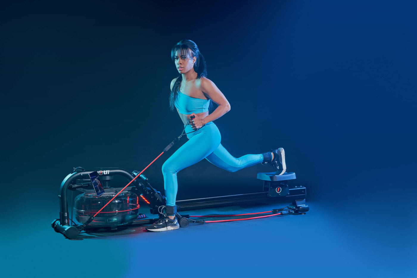 Woman in blue outfit doing lunge workout using LIT bands