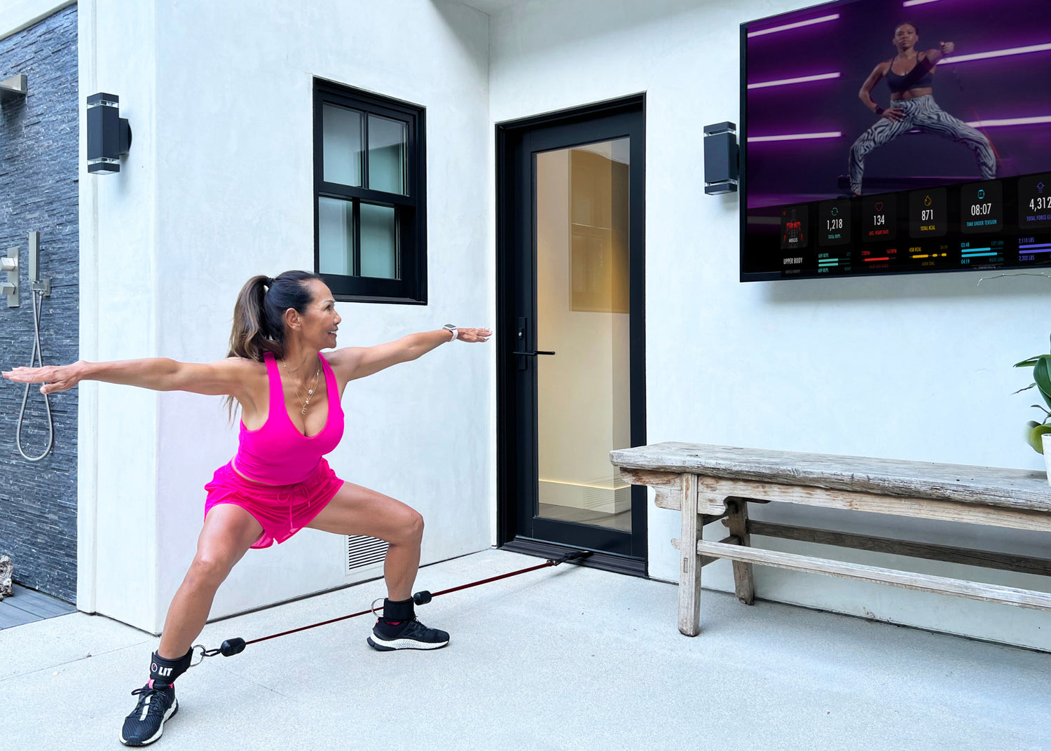 A woman doing workout with LIT Axis smart resistance bands