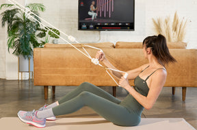 A woman doing workout with LIT Axis Pearl Portable Smart Resistance Band