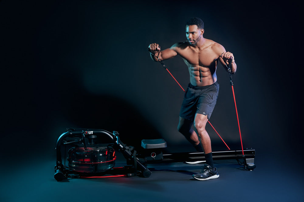 Male using LIT Bands to do a standing workout in a dark studio