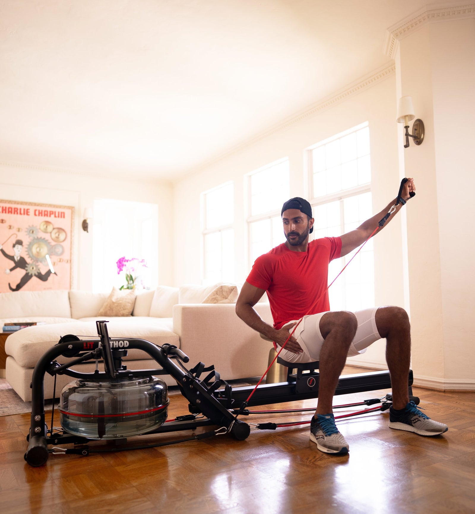 Male sitting on LIT strength machine use LIT bands to work out