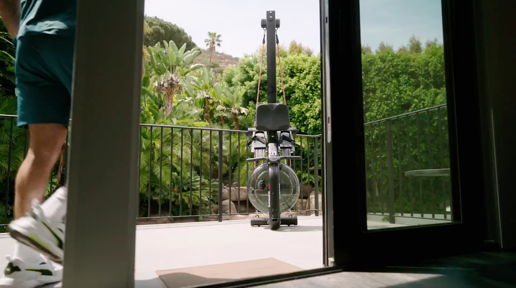 The Lit Strength Machine outside on California patio with green bushes