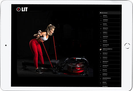 Woman in red pants doing a workout with LIT Bands in a dark room